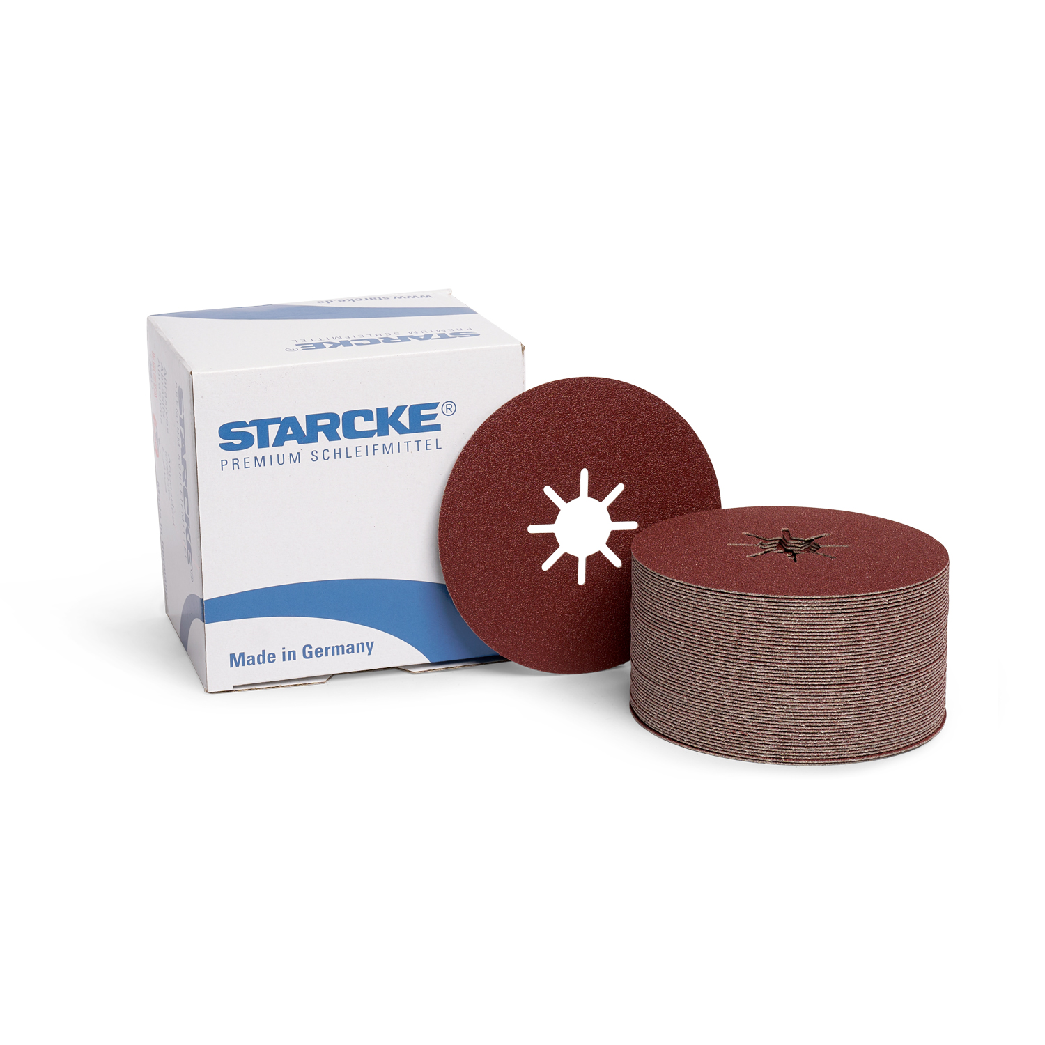 Braune Schleifscheibe vorm Karton mit kleinem Stapel